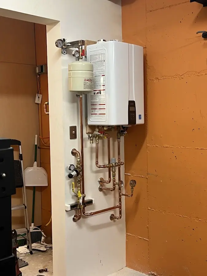 Plumbing technician inspecting water heater connections in Leesburg